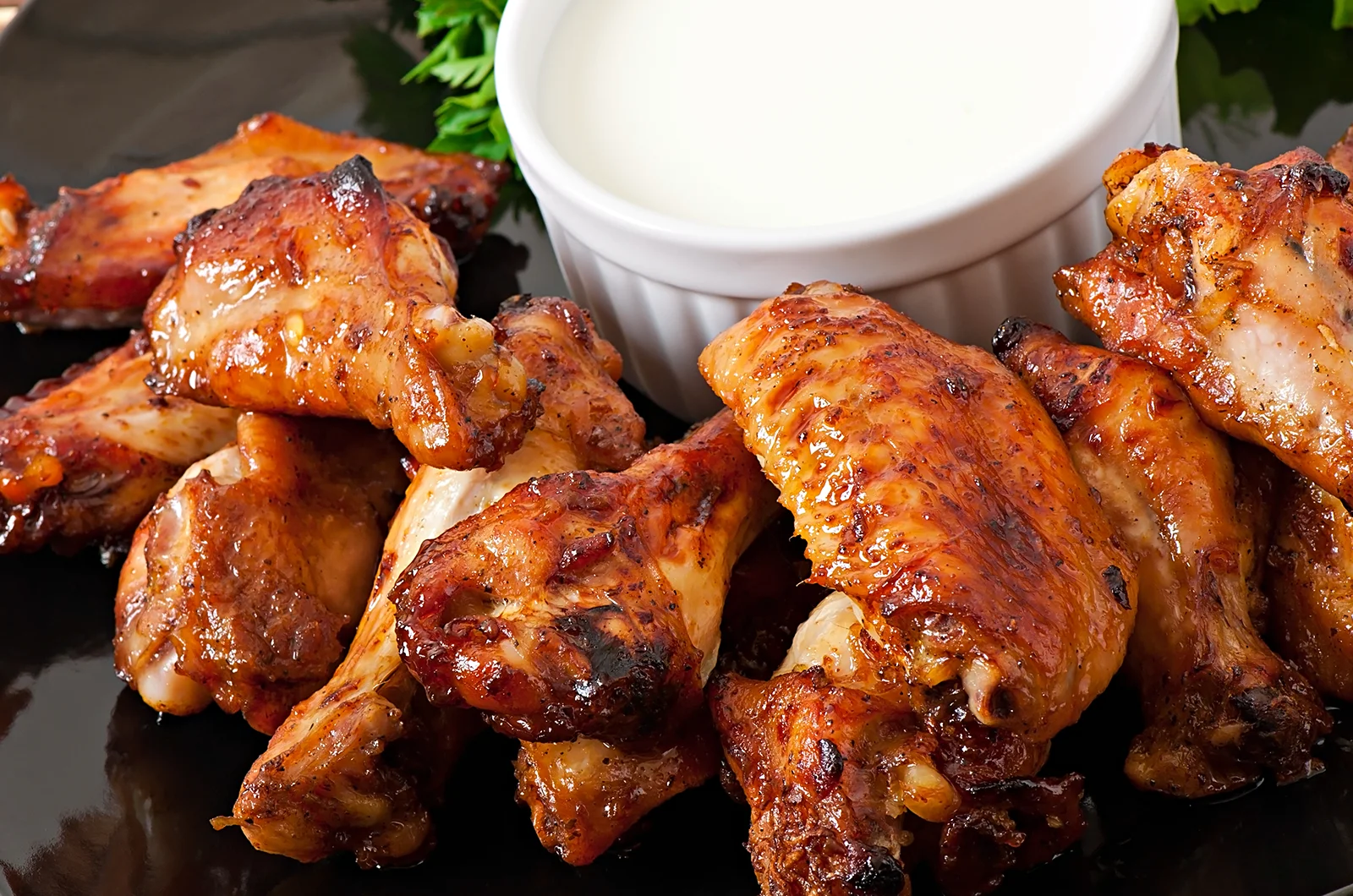 Chicken Wings served on a plate with ranch on the side
